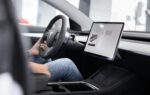 Auto In — The Future of Intelligent Mobility source : https://www.pexels.com/photo/man-sitting-by-steering-wheel-10029874/