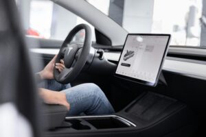 Auto In — The Future of Intelligent Mobility source : https://www.pexels.com/photo/man-sitting-by-steering-wheel-10029874/