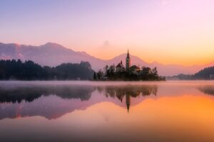 https://pixabay.com/photos/church-lake-sunset-panorama-bled-1993645/